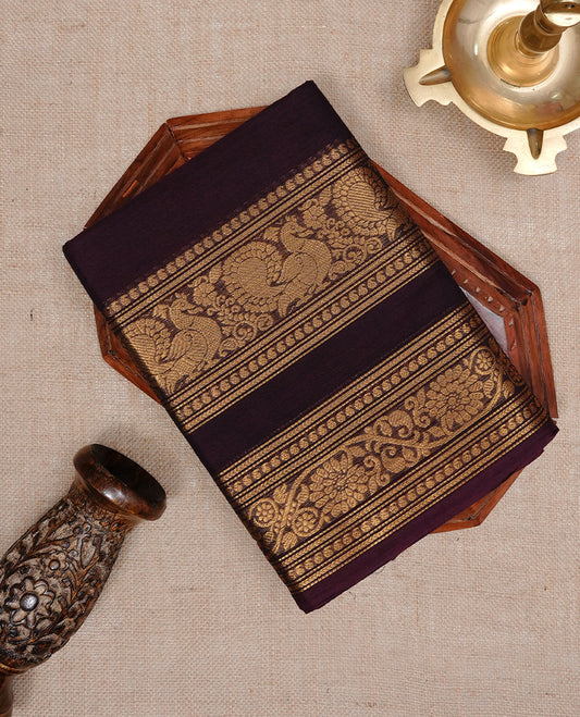 Chocolate brown colour Chettinad cotton saree featuring Elegant plain body, complemented by self colour with Gold zari border, paired with matching blouse piece.