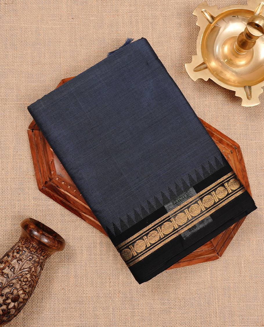 Bluish grey colour chettinad cotton saree featuring elegant plain body, complemented by black colour with zari border, paired with matching blouse piece.