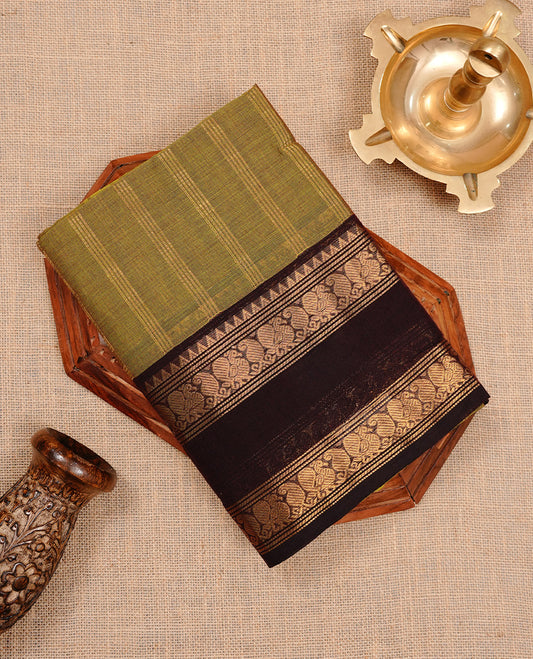 Olive colour chettinad cotton saree featuring gold zari stripes on body, complemented by dark chocolate colour with zari border, paired with matching blouse piece.