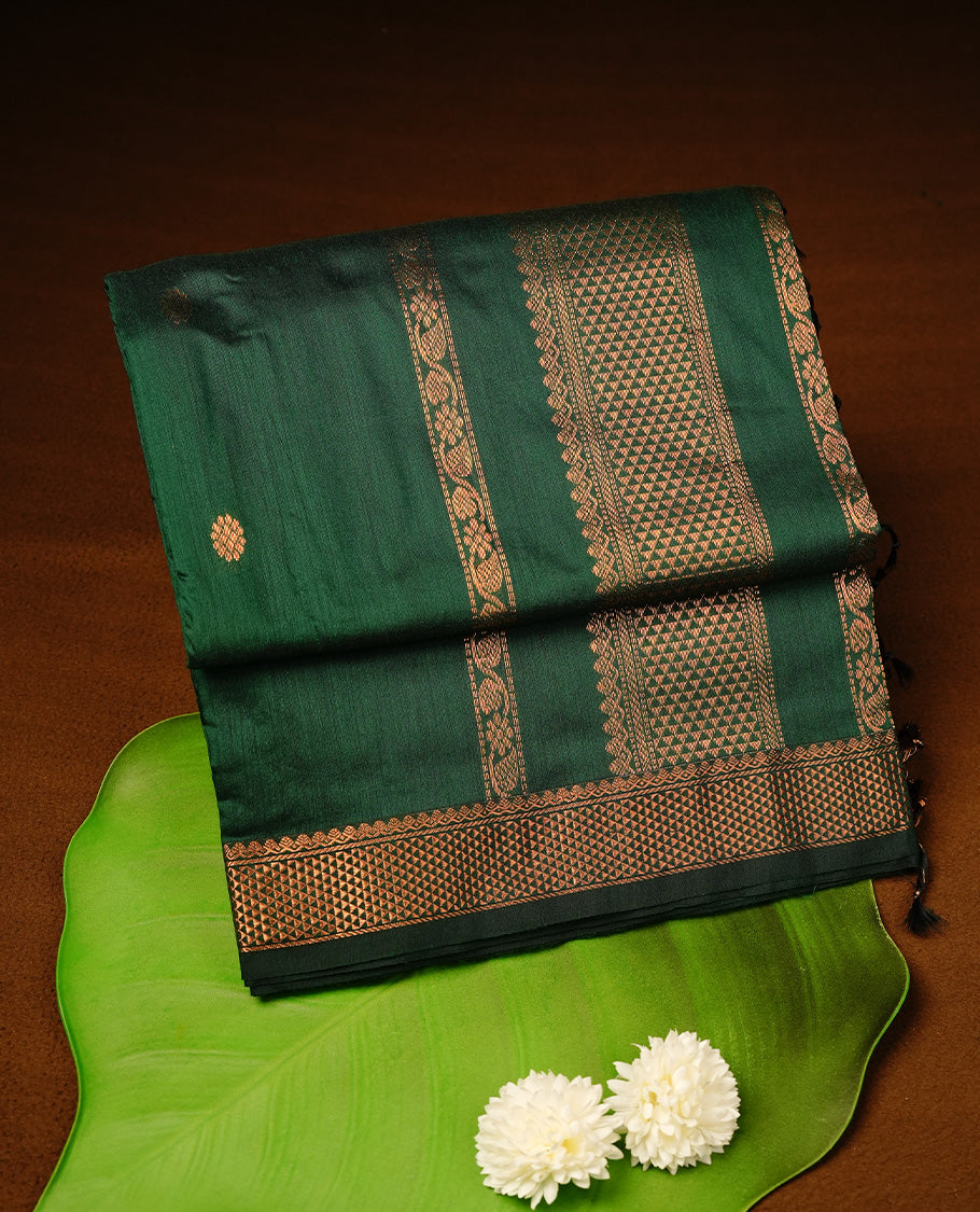 Green colour kalyani cotton saree featuring gold zari motifs on body, highlighting self colour with Antique gold zari border, paired with matching blouse piece.
