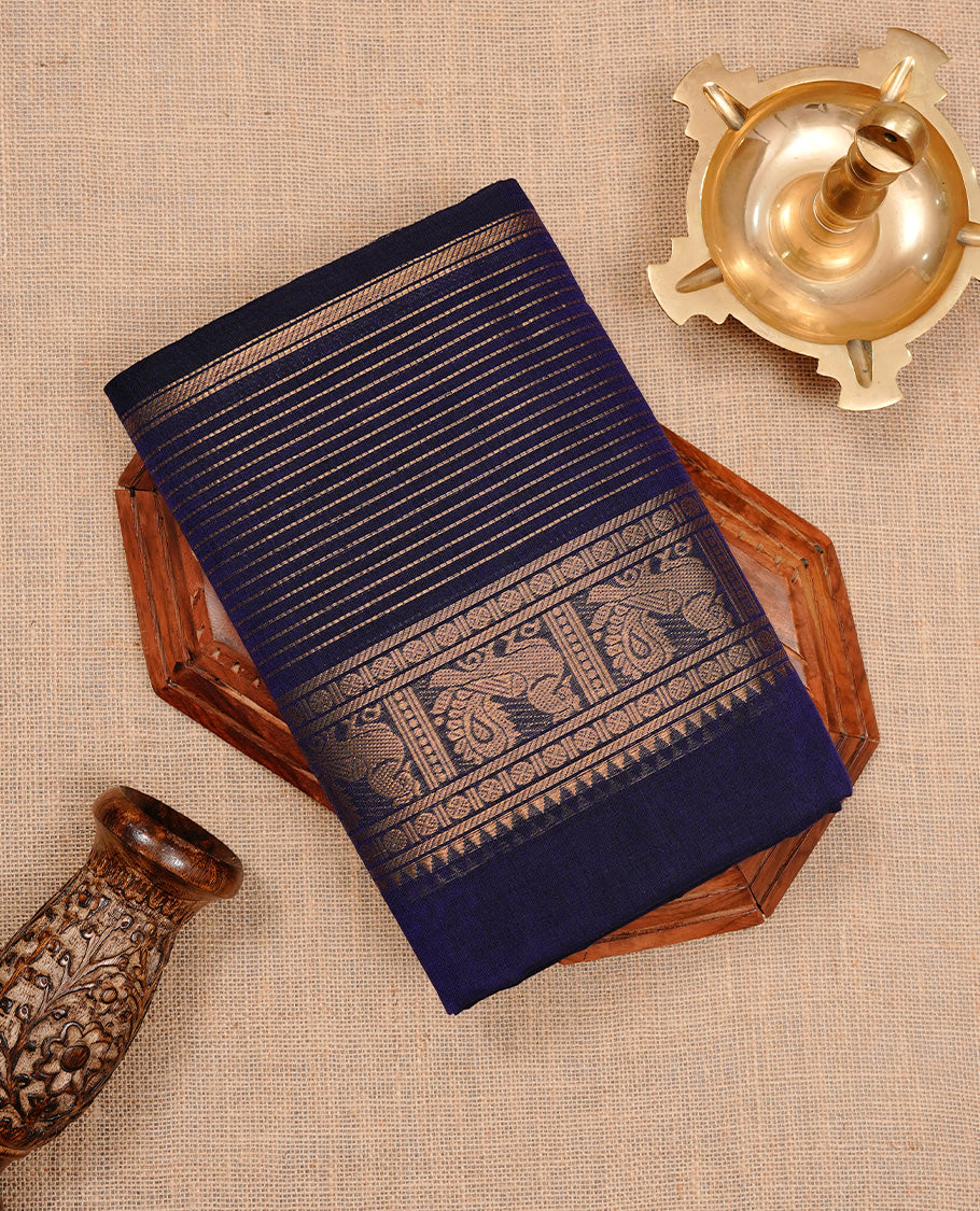 Navy blue colour chettinad cotton saree featuring Elegant plain body, complemented by self colour with zari border, paired with matching blouse piece.