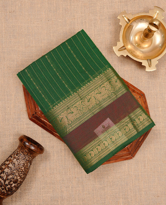 Green colour chettinad cotton saree featuring gold zari stripes on body, highlighting Mixed red colour with zari border, paired with matching blouse piece.