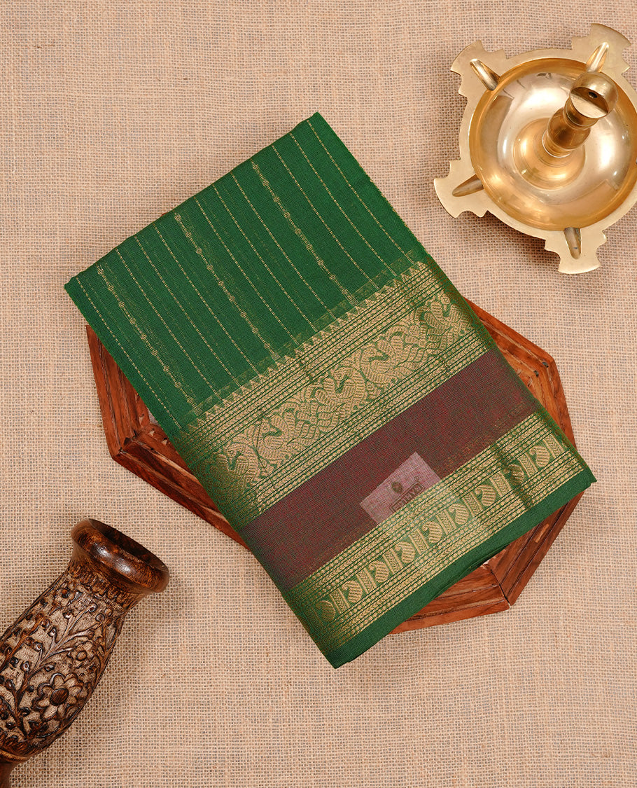 Green colour chettinad cotton saree featuring gold zari stripes on body, highlighting Mixed red colour with zari border, paired with matching blouse piece.