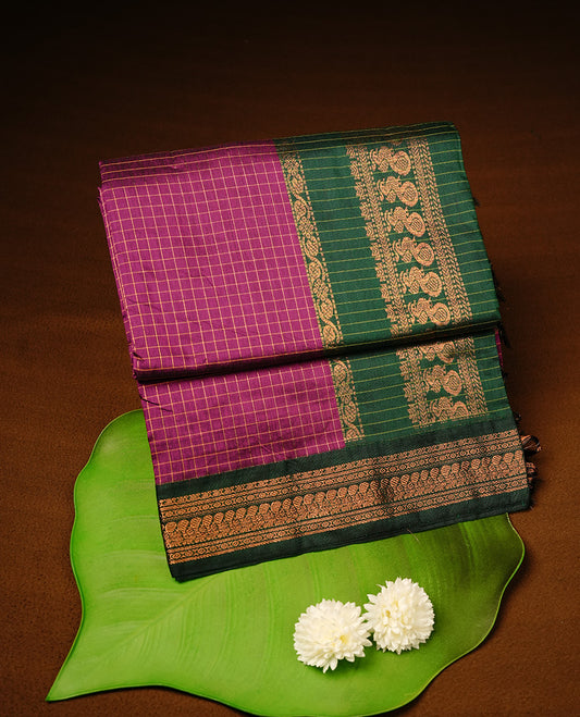 Purple colour kalyani cotton saree featuring gold zari check pattern on body, highlighting contrast green colour with Antique gold zari border, paired with matching blouse piece.