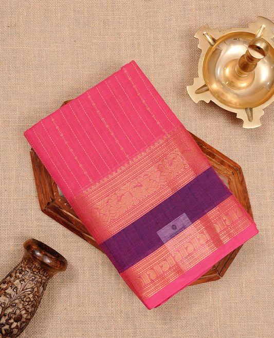 Magenta colour chettinad cotton saree featuring gold zari stripes on body, complemented by purple colour with zari border, paired with matching blouse piece.