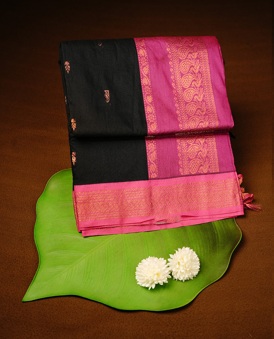 Black colour kalyani cotton saree featuring gold zari motifs on body, highlighting contrast Magenta colour with Antique gold zari border, paired with matching blouse piece.