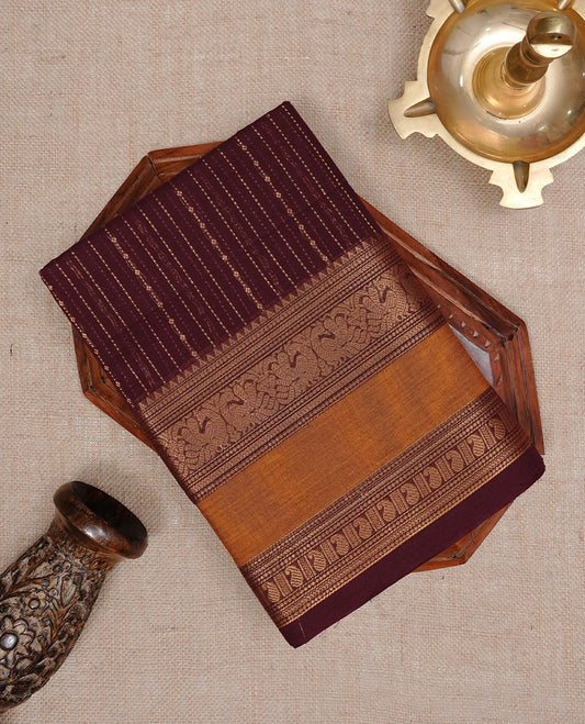 Maroon colour chettinad cotton saree featuring  gold zari stripes on body, complemented by Mustard border, paired with matching blouse piece.