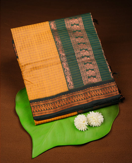 Mustard yellow colour mixed kalyani cotton saree featuring fine checked body, complemented by a dark green zari border and richly woven traditional pallu, paired with a matching blouse.