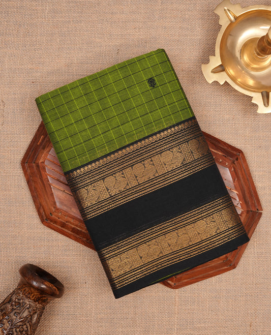 Green colour chettinad cotton saree featuring check pattern on body, complemented by contrast black with gold zari border, paired with matching blouse piece.