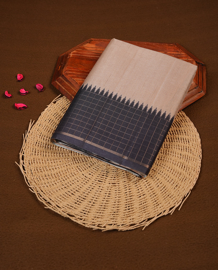 Beige colour semi tussar saree highlighting elegant plain body, contrast black colour border with gold zari box pattern, pallu and comes with matching blouse piece.