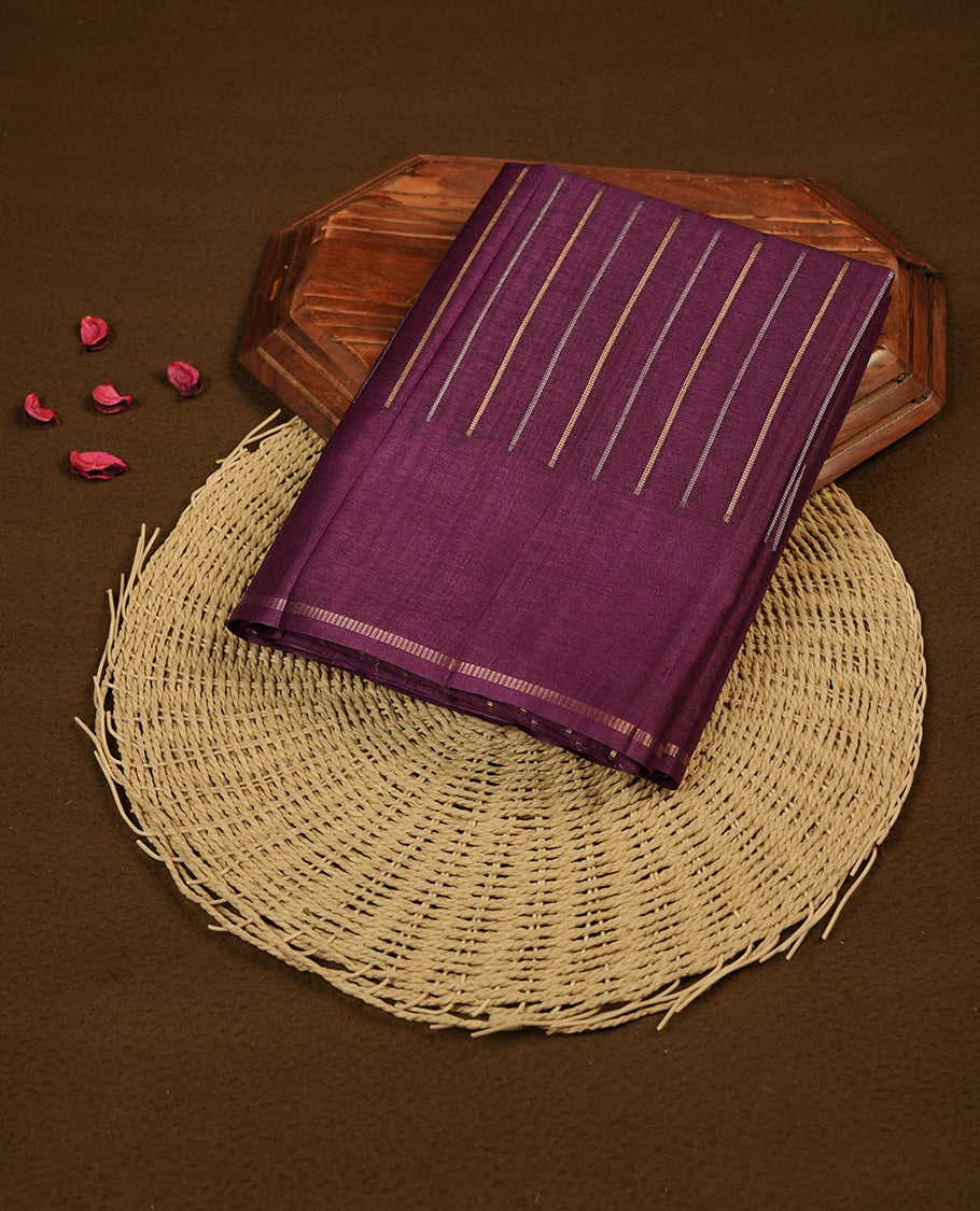 Purple colour semi tussar silk saree highlights gold and silver zari stripes across body,  border, pallu and paired with matching blouse piece.