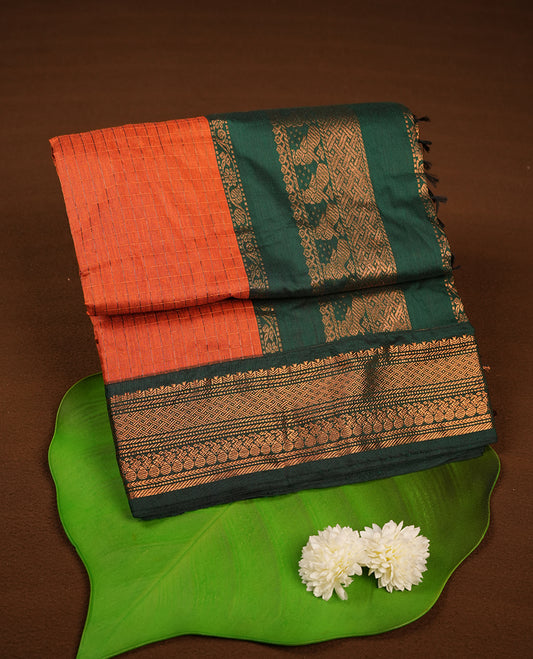 Burnt orange colour kalyani cotton saree featuring Antique zari check pattern on body, contrast Green colour border with antique zari pattern, paired with matching blouse piece.