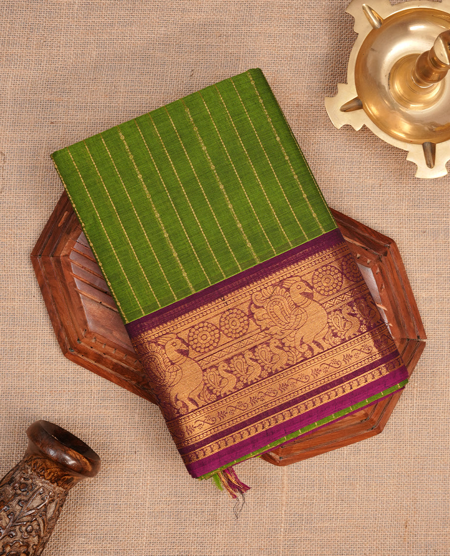 Lemon green colour chettinad cotton saree featuring gold zari stripes on body, complemented by contrast magenta colour with gold zari border, paired with matching blouse piece.