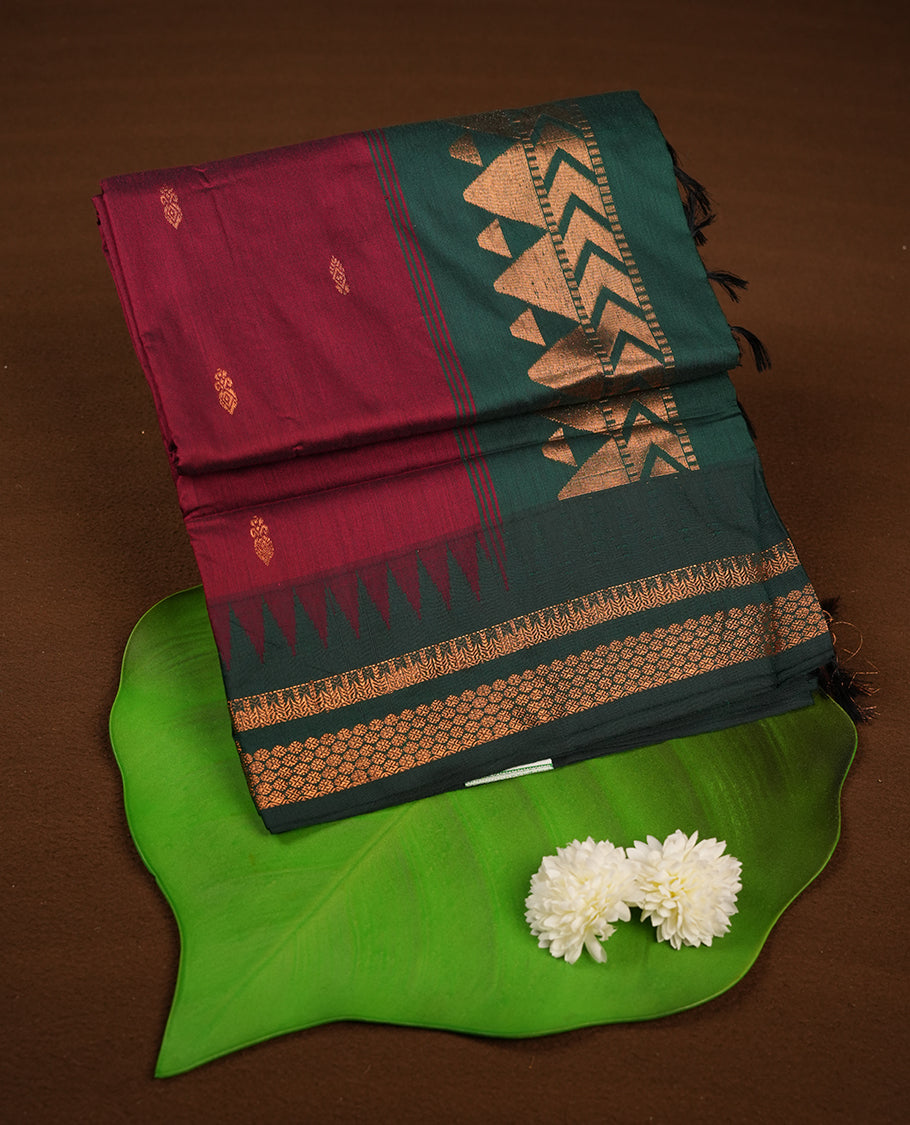 Maroon colour kalyani cotton saree featuring Antique zari motifs on body, contrast green colour border with geometric antique zari pattern, paired with matching blouse piece.
