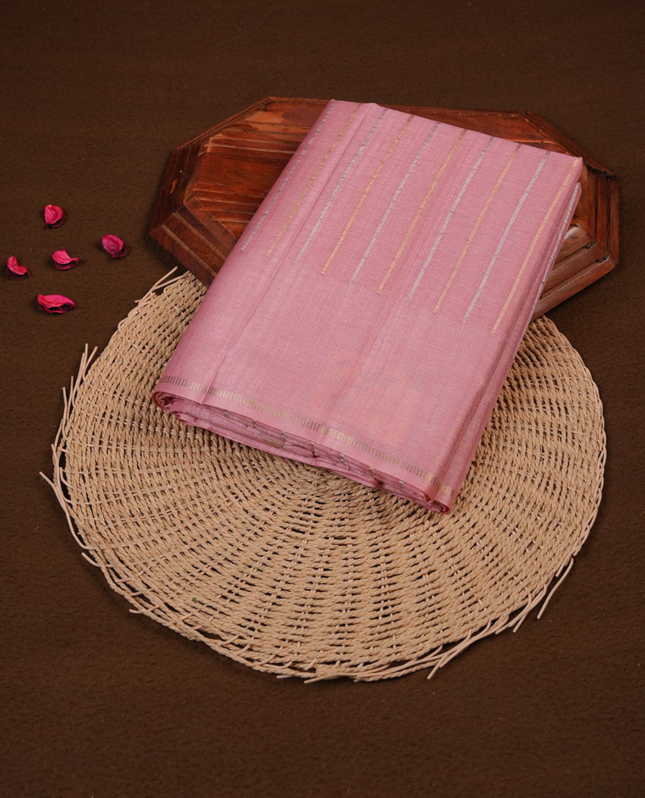 Pastel peach colour semi tussar silk saree highlights gold and silver zari stripes across body,  border, pallu and paired with matching blouse piece.