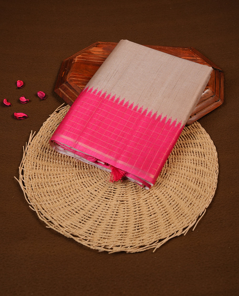 Beige colour semi tussar silk saree highlighting elegant plain body, contrast pink colour border with gold zari box pattern, pallu and comes with matching blouse piece.
