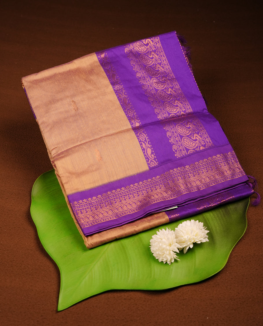 Antique gold colour Kalyani cotton saree featuring a plain elegant body, complemented by a rich Purple zari border and traditional woven pallu, paired with a matching blouse.