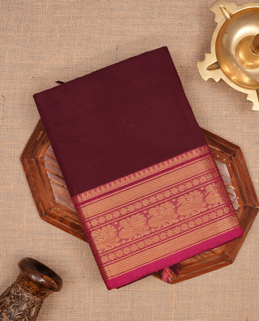 Maroon colour chettinad cotton saree featuring elegant plain body, complemented by contrast magenta colour with gold zari border, paired with matching blouse piece.
