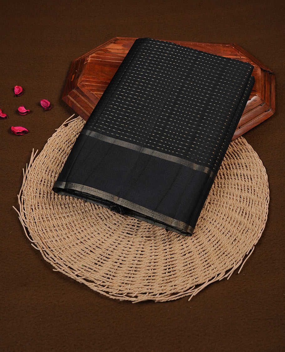 Black colour semi tussar silk saree highlighting gold zari dotted stripes, self colour border and contrast dark gold pallu and comes with matching blouse piece.
