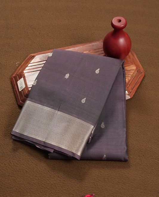 Purple taupe colour semi soft silk saree featuring a gold peacock & floral motifs body, complemented by gold traditional pallu & border and a matching blouse piece.