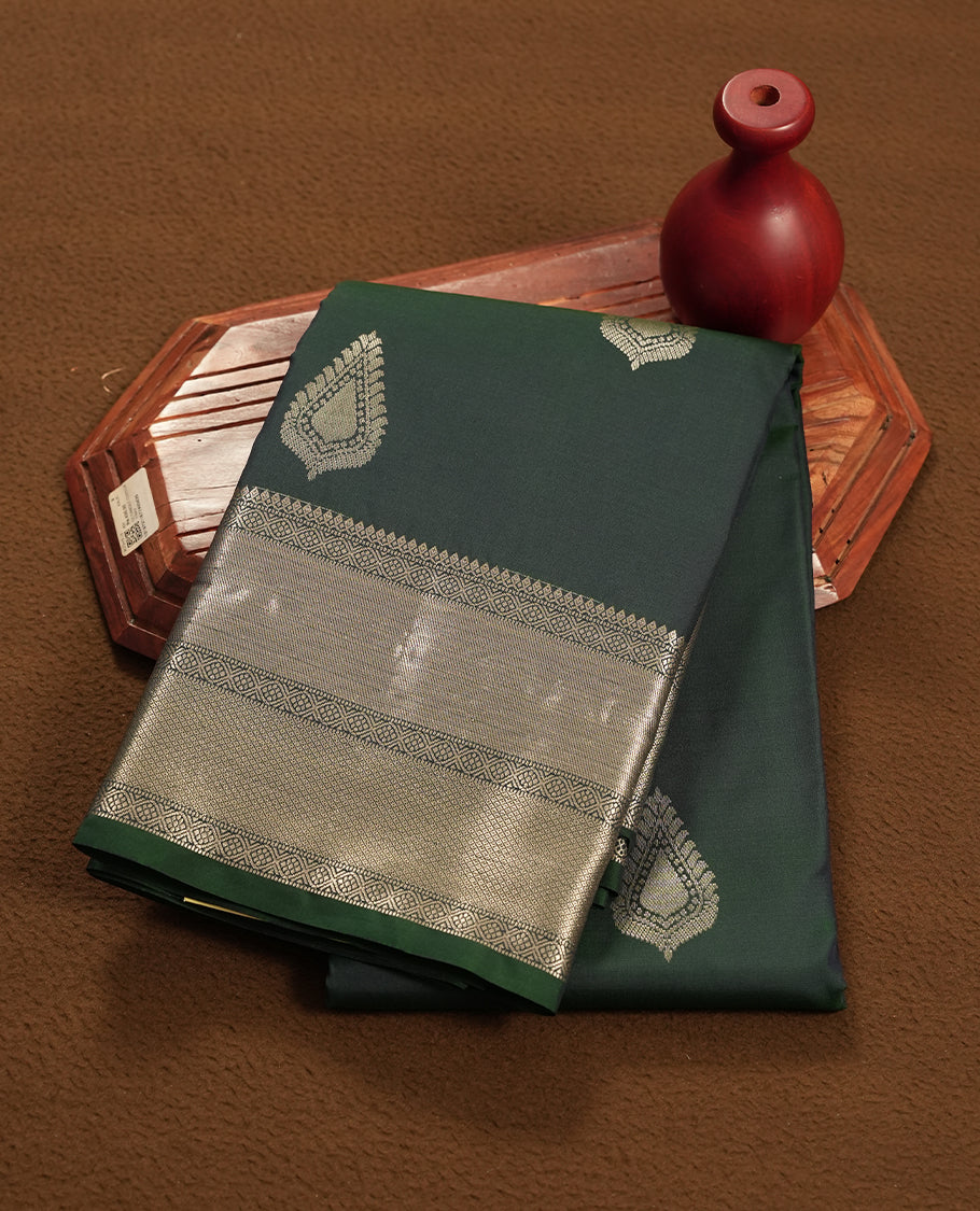 Dark Green colour semi soft silk saree featuring a gold leaf patterned body, complemented by gold traditional pallu & border and a matching blouse piece.