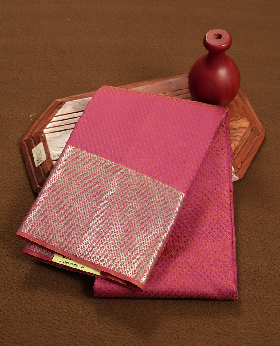 Dark magenta colour semi soft silk saree featuring a self coloured textured patterned body, complemented by self coloured golden tiny diamond motifes on pallu & border and a matching blouse piece.