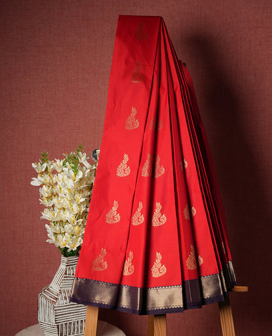 Red colour Semi Silk Saree with gold zari patterns on the body, paired with a contrasting dark purple traditional pallu and border, and a matching blouse piece.