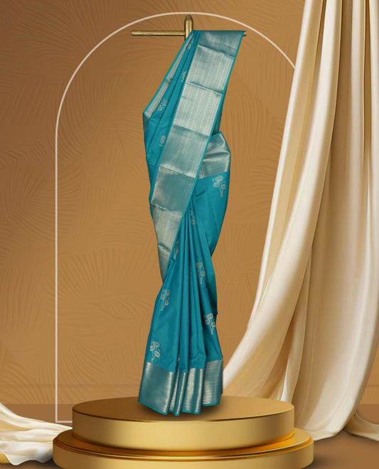 Sky blue colour soft silk saree with silver zari border and matching blouse, featuring delicate silver floral motifs on the body & Paired with a matching blouse.
