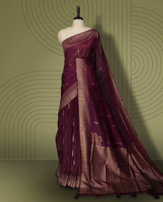 Grape colour semi Banarasi Tussar Georgette saree with delicate gold zari buttas on the body, a rich golden zari pallu, and detailed woven border & Comes with a matching blouse piece.