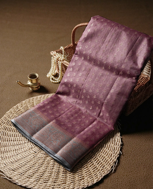 Mauve colour Pure Banarasi Tussar Saree , featuring intricate zari motifs, contrast grey colour traditional border, woven pallu, and matching blouse.