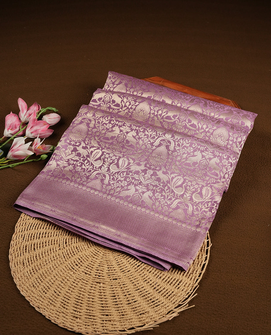 Lavender colour Mysore Crepe Silk saree fearturing gold zari kodi visiri & Animal brocade pattern on body and self colour border paired with matching blouse