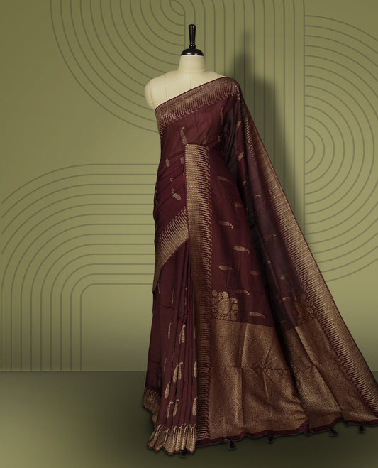 Dark coffee brown colour semi Banarasi Tussar Georgette saree with delicate gold zari buttas on the body, a rich golden zari pallu, and detailed woven border & Comes with a matching blouse piece.