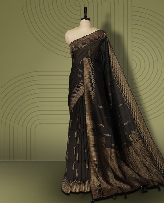 Black colour semi Banarasi Tussar Georgette saree with delicate gold zari buttas on the body, a rich golden zari pallu, and detailed woven border & Comes with a matching blouse piece.