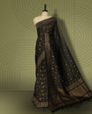 Black colour semi Banarasi Tussar Georgette saree with gold zari motifs on the body, a grand woven golden pallu, and ornate zari border, Includes a matching blouse piece for a complete look.