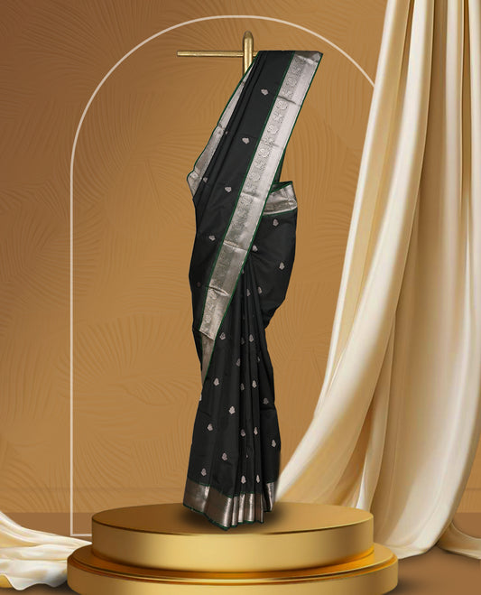 Black colour soft silk saree with green and copper zari border and featuring elegant copper buttas across the body & Paired with a amatching blouse.