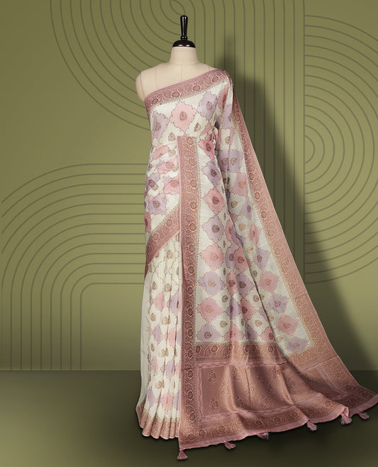 Pastel cream colour semi Banarasi Tussar Georgette saree with blush pink and lilac zari floral motifs, ornate dusty rose border and rich pallu & Includes a matching unstitched blouse piece to complete the look.