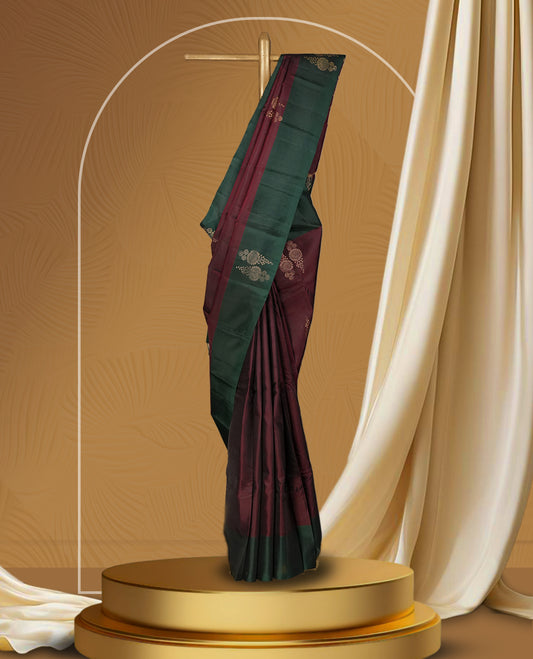 Dark brown colour  soft silk saree adorned with zari motifs, beautifully contrasted with a deep green border and pallu & Paired with a matching blouse.
