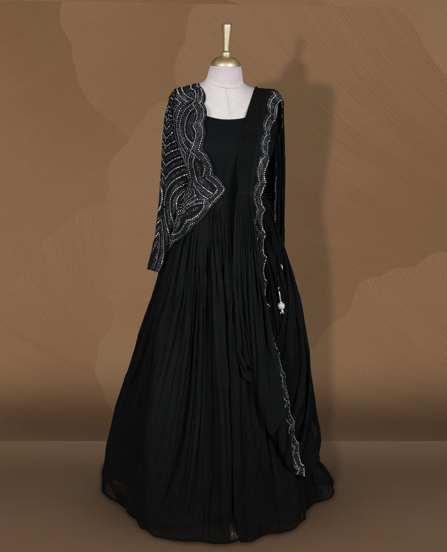 Black colour stitched gown set with sleeveless square‑neck bodice, attached pleated flare, and one‑side draped dupatta highlighted with heavy silver sequin and mirror work borders.