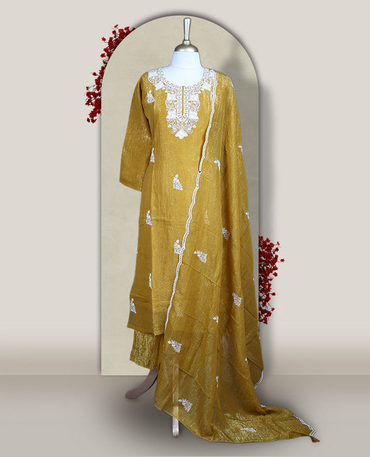 Mustard yellow churidar set featuring elegant white thread embroidery on the neckline, sleeves, and scattered motifs across the body, Paired with a matching embroidered dupatta, this ensemble radiates graceful charm and festive appeal.