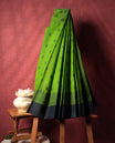 Lemon green colour silk cotton saree featuring elegant floral zari motifs on the body, complemented by a rich contrast dark border and pallu with traditional woven detailing & Comes with a matching blouse piece.