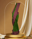 Green colour soft silk saree adorned with minimal golden motifs, paired with a contrasting maroon border and pallu featuring elegant zari patterns & Comes with a matching blouse.
