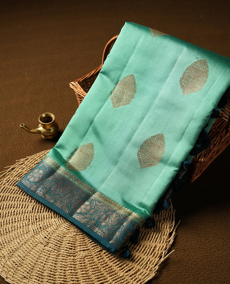 Aqua green Banaras soft silk saree with gold zari oval motifs on body, with contrast Dark Teal colour floral pattern on pallu, border, and Matching blouse.