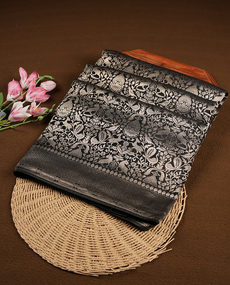 Black colour Mysore Crepe Silk saree fearturing gold Zari kodi visiri & Animal brocade pattern on body and self colour border paired with matching blouse