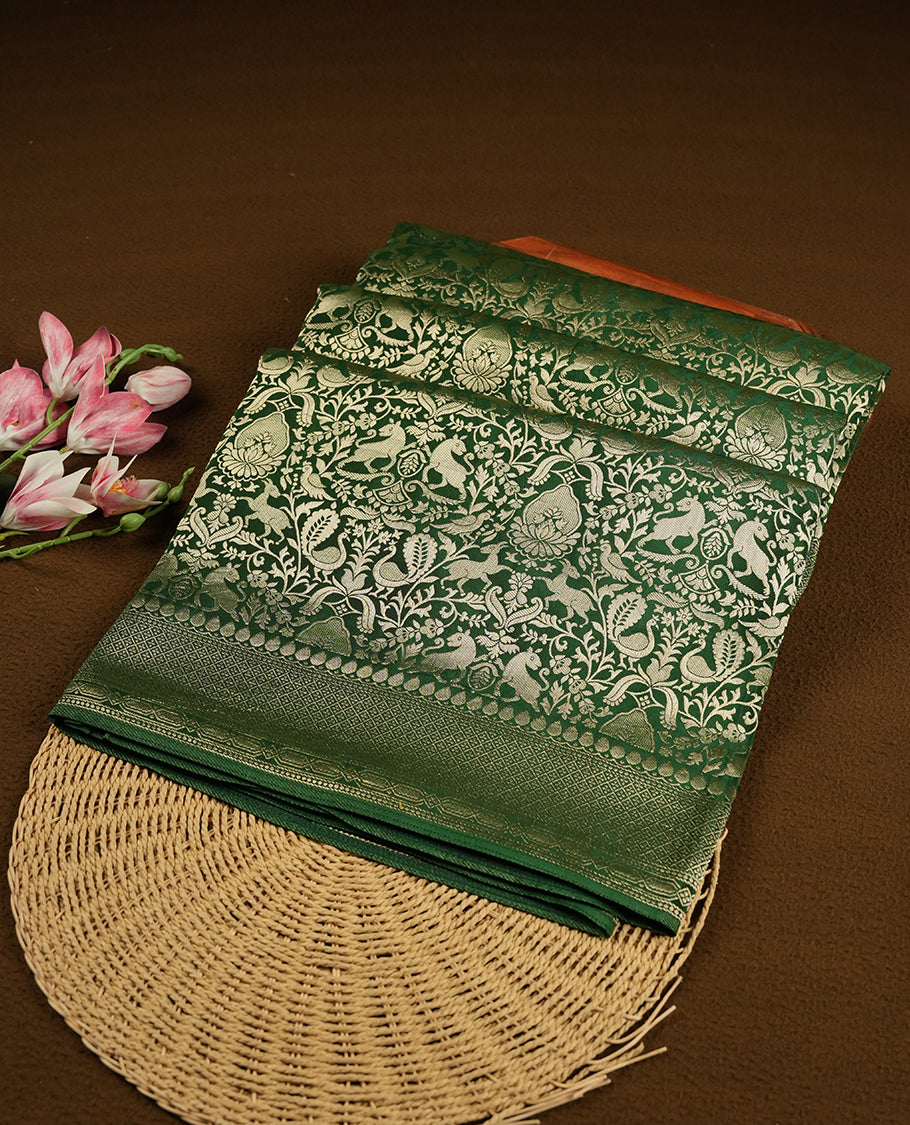 Dark Green colour Mysore Crepe Silk saree fearturing gold Zari kodi visiri & Animal brocade pattern on body and self colour border paired with matching blouse