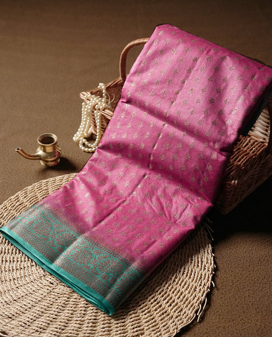 Pink colour pure tussar silk saree adorned with subtle silver zari motifs all over, complemented by a rich contrast aqua blue Banarasi border & Comes with a matching blouse piece.