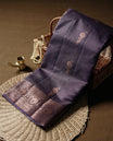 Cyber grape colour pure banarasi tussar Saree with antique design & golden motifs on the body, accentuated with an elegant traditional border, rich woven pallu and matching blouse piece.