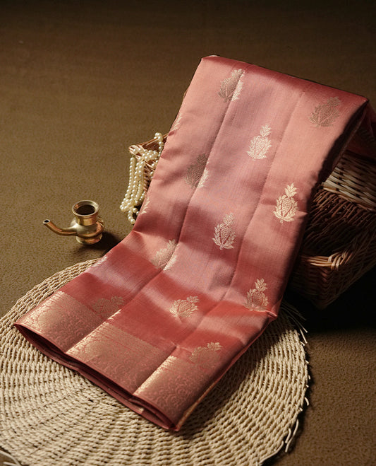 Rust orange colour pure banarasi tussar saree adorned with delicate golden motifs all over the body, complemented by an intricate Banarasi style silver zari border & Comes with a matching blouse piece.