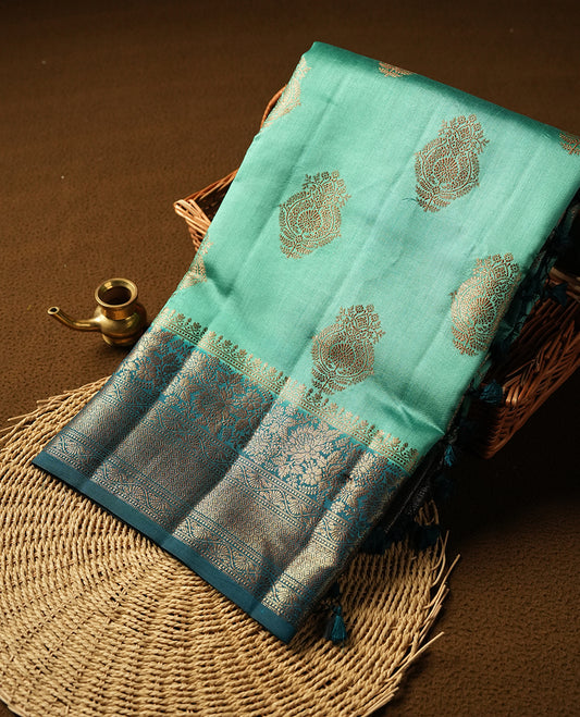 Teal Banaras soft silk saree with gold zari motifs on body, with contrast Dark teal colour floral pattern on pallu, border, and Matching blouse.