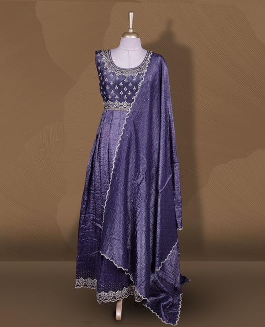 Dark purple colour stitched gown set with sleeveless embroidered yoke, flared ankle‑length silhouette, and attached dupatta featuring dainty butti work and scalloped beaded edging.