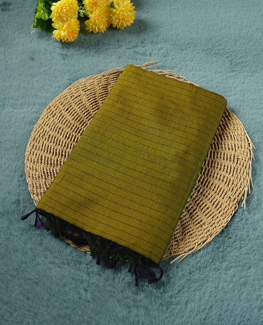 Olive Green colour poly cotton saree with black vertical dotted line pattern on the body, paired with a matching pallu featuring black zigzag geometric border, and a coordinated all‑over black stylised fleur‑de‑lis printed blouse piece.